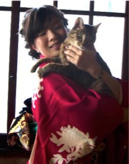One of the researchers, Saho Takagi, holding her cat. (Image: Mayu Takagi)